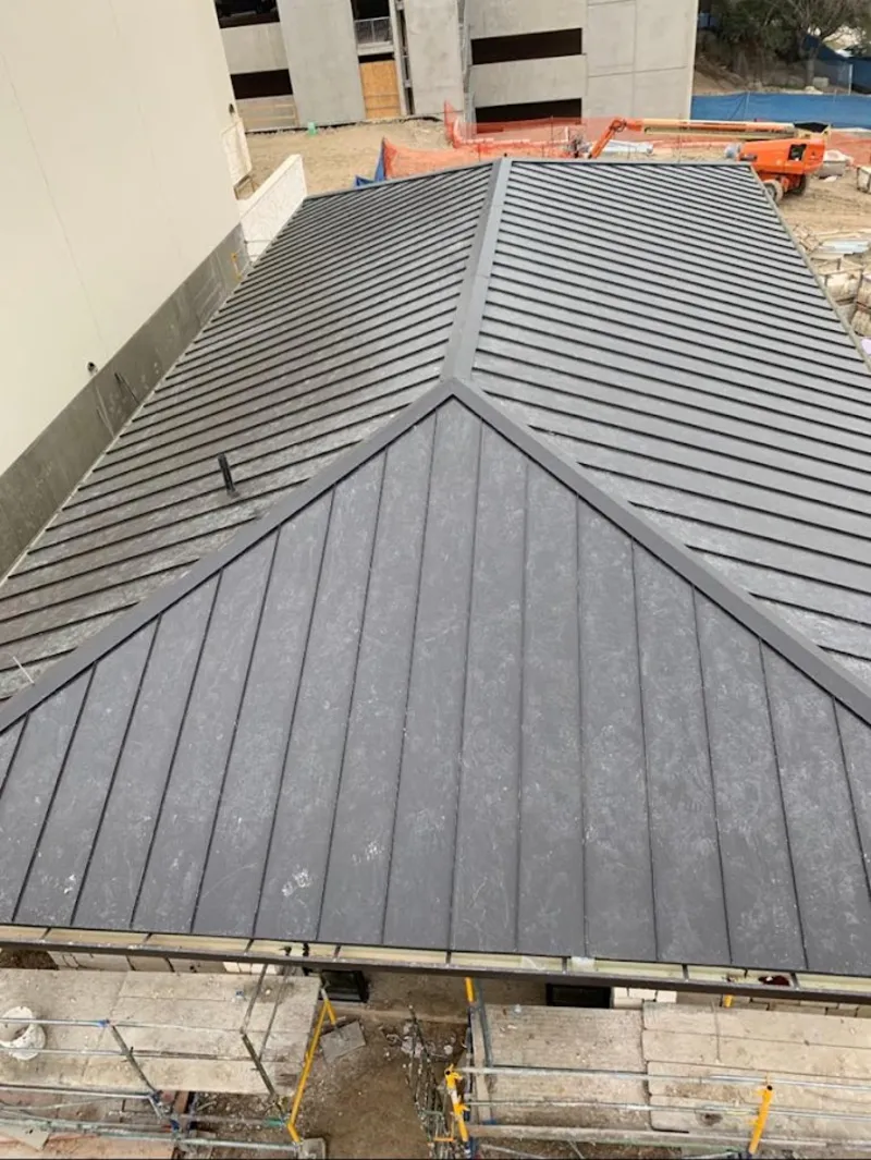 Commercial metal roof construction with crane equipment in La Mirada