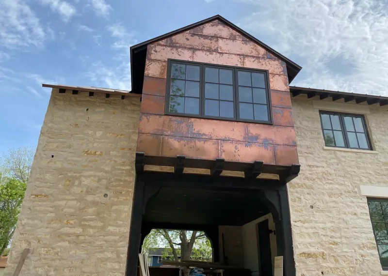 Copper metal panel facade on a stone building for Skylight Installation in La Mirada